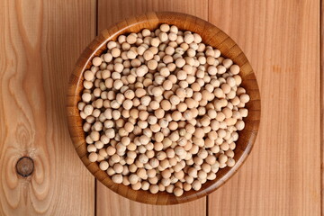 Whole yellow peas in wooden bowl