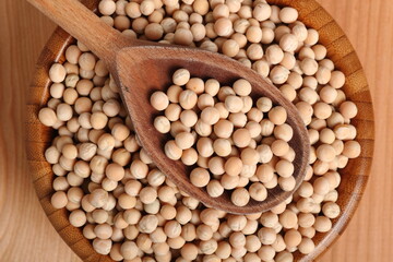 Whole yellow peas in wooden bowl