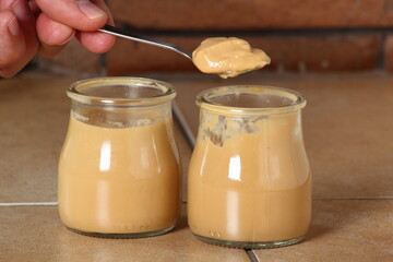 Eating milk pudding dessert in jar and cookies