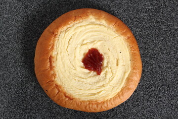 Sweet roll. Yeast bun with cheese and jam filling in the middle.
