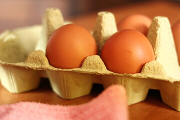 Eggs in carton pack. Making mayonnaise with a wooden spoon.