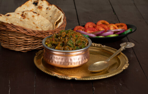 Indian Cuisine Bhindi Masala on Wooden Background