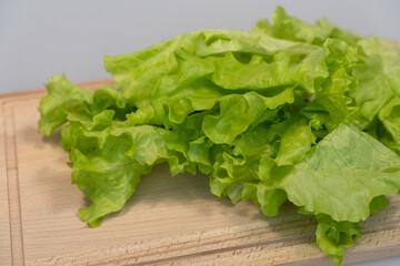 fresh green lettuce leaves lie on the table