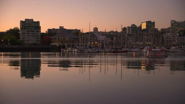 Vancouver, British Columbia, Canada &ndash; September 28, 2017. False Creek Water Taxi Morning Editorial 4K UHD. A False Creek morning at sunrise in Vancouver. British Columbia, Canada. 4K UHD.

