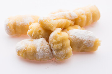 A pile of gnocchi on a white background