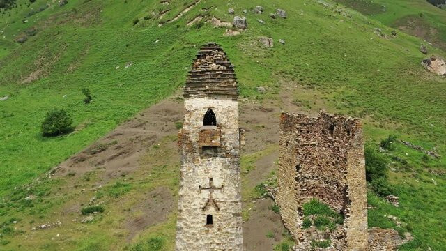 Aerial around view of medieval tower complex in the mountains of Ingushetia, Russia, 4k