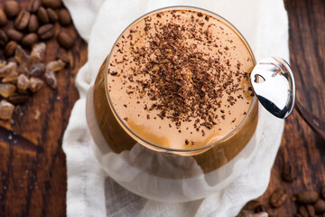 Dalgona coffee in glass cup. Korean trendy drink from instant coffee, milk and brown sugar