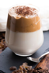 Dalgona coffee in glass cup. Korean trendy drink from instant coffee, milk and brown sugar