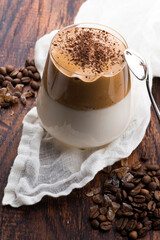 Dalgona coffee in glass cup. Korean trendy drink from instant coffee, milk and brown sugar