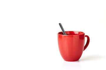 Coffee mug and spoon a white background