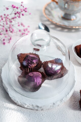 Handmade chocolate truffle on a festive white table. Dorblu sweets