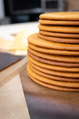 Cooking honey cake at home. Many round baked cakes on top of each other, blanks without cream.