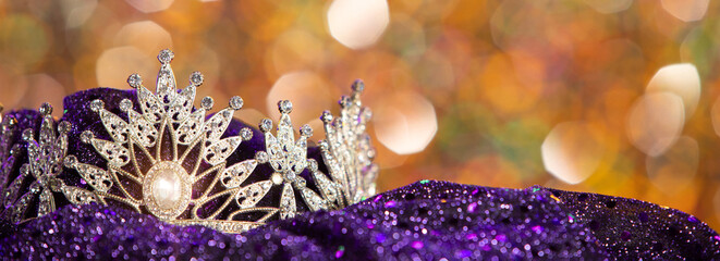 Silver Sparkling Diamond Crown shines on yellow orange bokeh as background for miss beauty queen pageant contest, copy space banner
