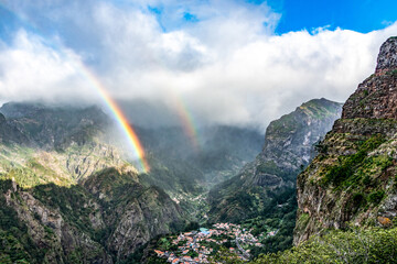 Panoramic mountains view from Eira do Serrado viewpoint with rainbow above the Nun's Valley on Madeira Island Portugal