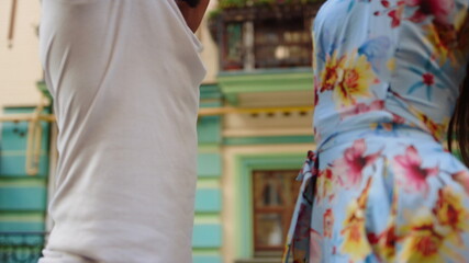 Afro couple dancing with passion in city. Male dancer controlling girl on street