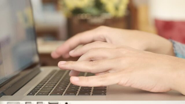 Typing on keyboard. Female hands typing on keyboard from side view closeup 4K. Business woman working home office using laptop. Using technology working productive.