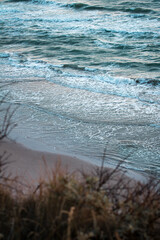 calm teal beach waves coming in at danish coast