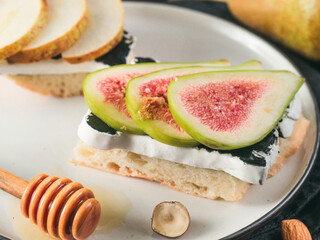 Toast with black camembert cheese and figs slices on plate. Healthy snack or breakfast idea and reciepe.