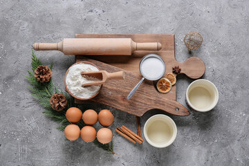 Fototapeta na wymiar Ingredients for Christmas bakery and kitchen utensils on grunge background