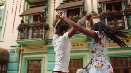 African american man and woman curling in city. Couple synchronizing moves