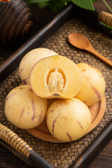 Fresh fruit ginseng fruit on the background of retro Chinese style tea plate