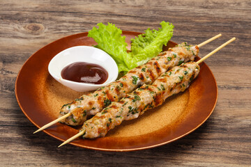 Minced pork skewer kebab with sauce