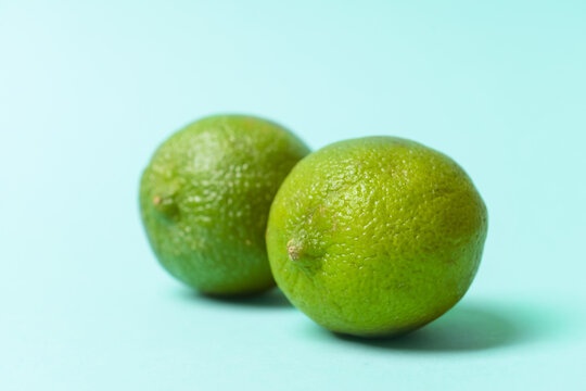 Fresh juicy limes on color background. Erotic and female health care concept