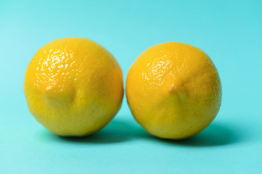 Fresh juicy lemons on color background. Erotic and female health care concept