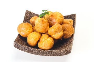 Sweet tasty profiteroles heap in the bowl