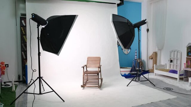Photo or video studio with two hexagone studio lights. White screen and rocking chair