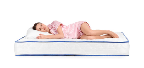 Young woman lying on mattress against white background
