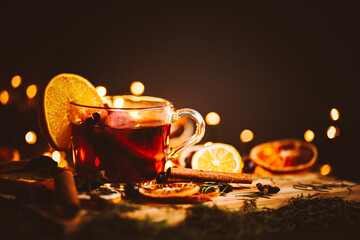 Christmas mulled wine, Drink with dried fruits and berries, Winter hot tea in a glass and spices on...
