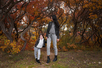 Fototapeta premium happy mother and child daughter walk in the autumn