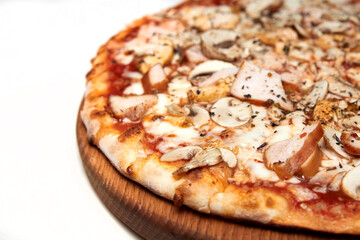 Fresh pizza with bacon, tomatoes, mushrooms and cheese on a light background. Close-up, selective focus