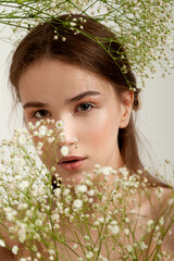 Portrait of a beautiful young girl with gypsophila flowers.