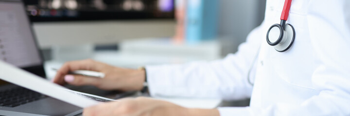 Medical officer at workplace in the office works at computer. Medical statistics on diseases concept