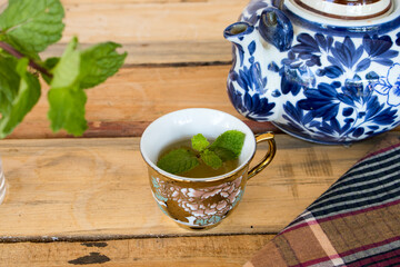 herbal healthy drinks hot tea honey lemon for health care with peppermint leaf and lemon slice for relaxation on background  wooden