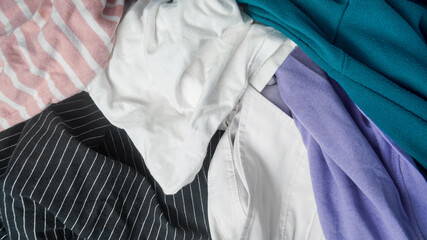 Pile of different used clothes texture background.
