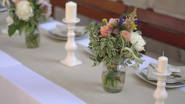 serving and decorating of the table with flowers and candlesticks at the wedding banquet 