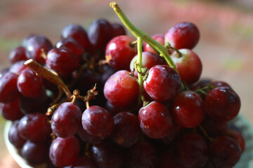 Healthy fruits Red wine grapes background/ dark grapes/ blue grapes/wine grapes,Red wine grapes background/dark grapes,blue grapes,Red Grape in a supermarket local market bunch of grapes ready to eat
