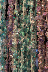 Naklejka premium Full frame photo of colorful buttons hanging at threads. Soft focus, shallow depth of field.