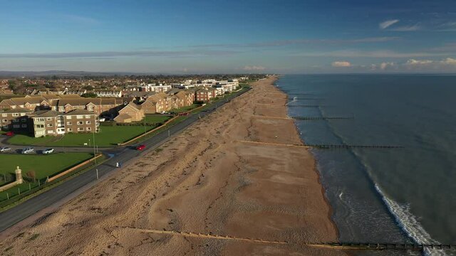 Rustington Seafront in West Sussex England aerial footage along the beach of this popular residential village on the south coast of England.