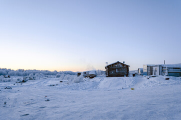 Winter sunset in one of the coldest places on earth, in the village Oymchkon in the Russian North
