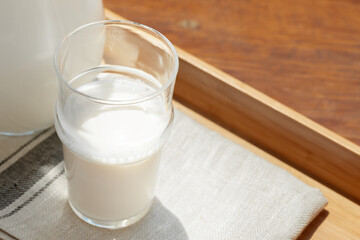 Glass cup of milk on table close up