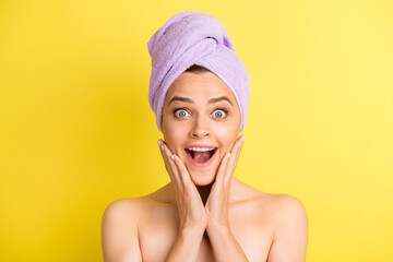 Close-up portrait of pretty amazed cheerful girl enjoying procedure fresh skin isolated over vivid yellow color background