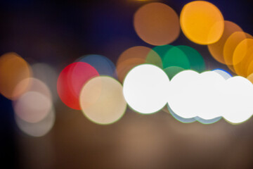 Out of focus defocused blurred bokeh of cars and traffic lights at night on city street.