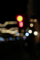 Out of focus defocused blurred bokeh of cars and traffic lights at night on city street.