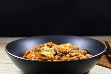 Pad Thai, Spicy Fried and stirred noodle with traditional sauce and mixed with egg and shrimp on the plate. Popular menu in Thailand street food.