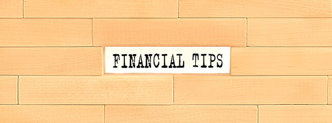 FINANCIAL TIPS text on the wooden block wall, business