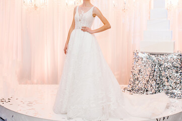 Fototapeta premium Bride at ceremony in wedding day. Woman in an expensive, luxury dress, details of models on the collection catwalk during the Bridal Week runway.